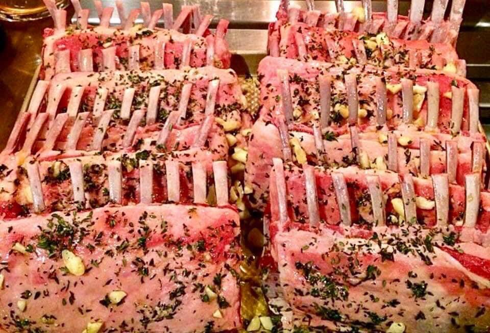 Herb-crusted racks of lamb ready for the oven